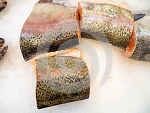 Sliced Ã¢â¬â¹Ã¢â¬â¹salmon on ice. Pieces of the freshest fish on the counter photo